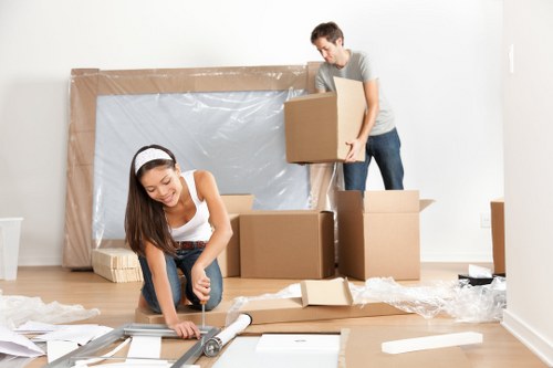 Removal team planning a London house move with packed boxes and furniture