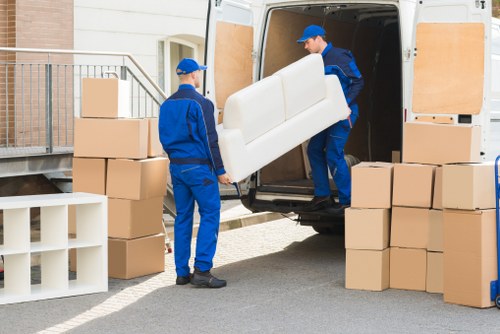 Professional movers arranging furniture inside a London home