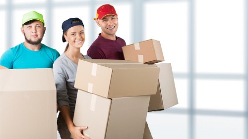 Business furniture being moved through an office building corridor