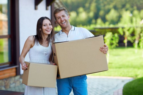 Movers loading household items into a removal van in London
