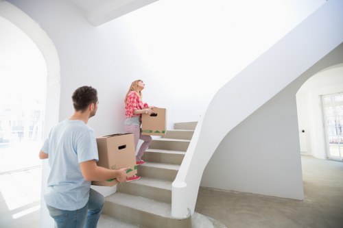 Boxes and wrapped furniture being unloaded into a new London home