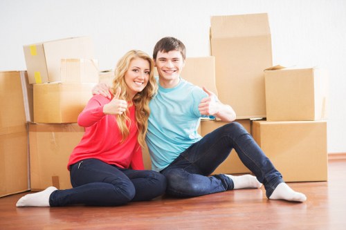 Team moving office furniture and equipment into a London workspace