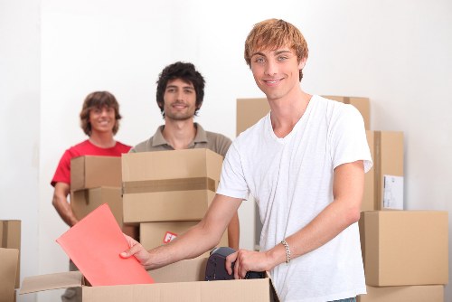 Professional movers handling a flat removal in a London residential building