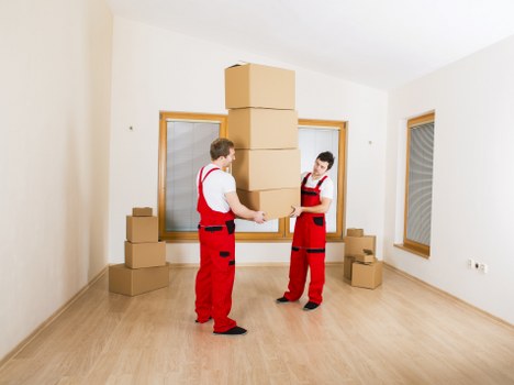 Removal team handling packing and loading in a London property